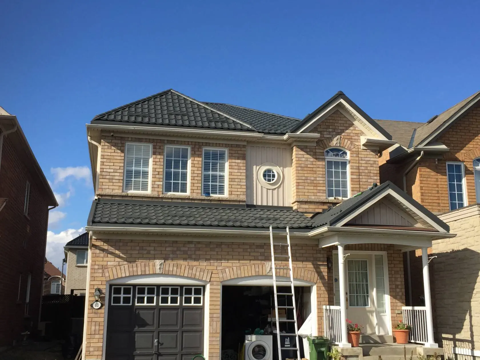 New metal roof grey colour on yellow brick house